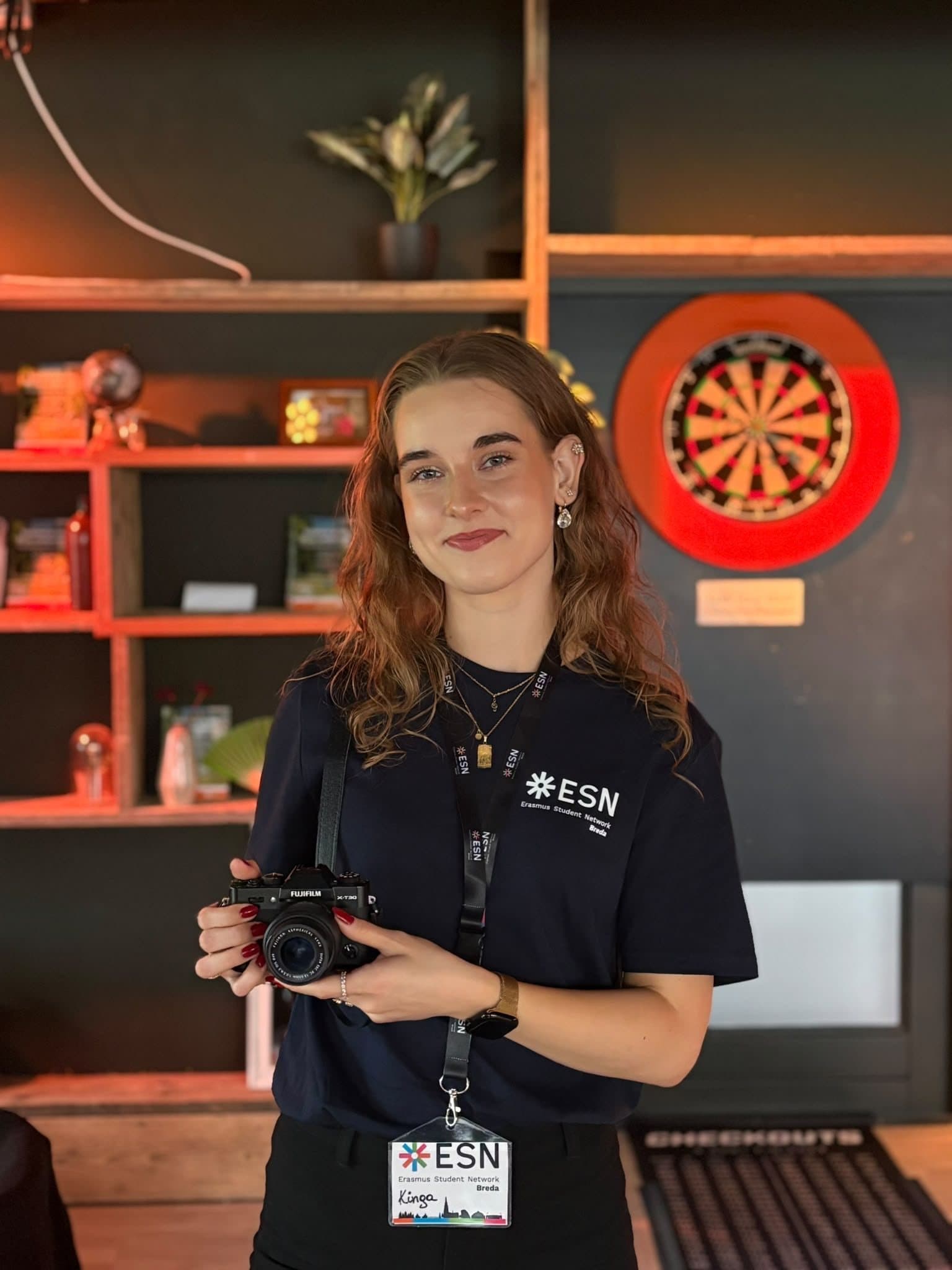 Kinga holding a camera at an ESN event