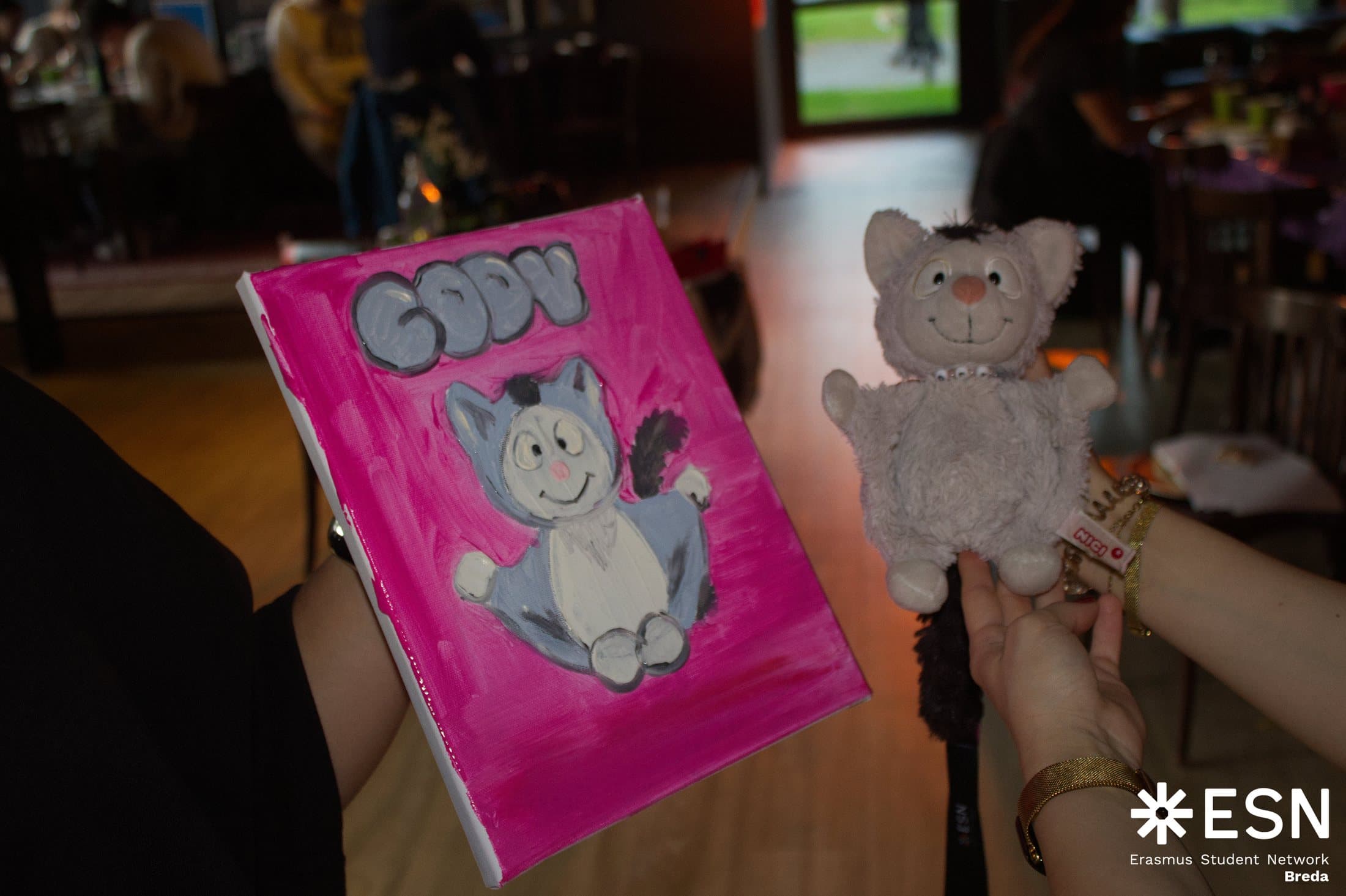 A participant's drawing beside the ESN Breda mascot
