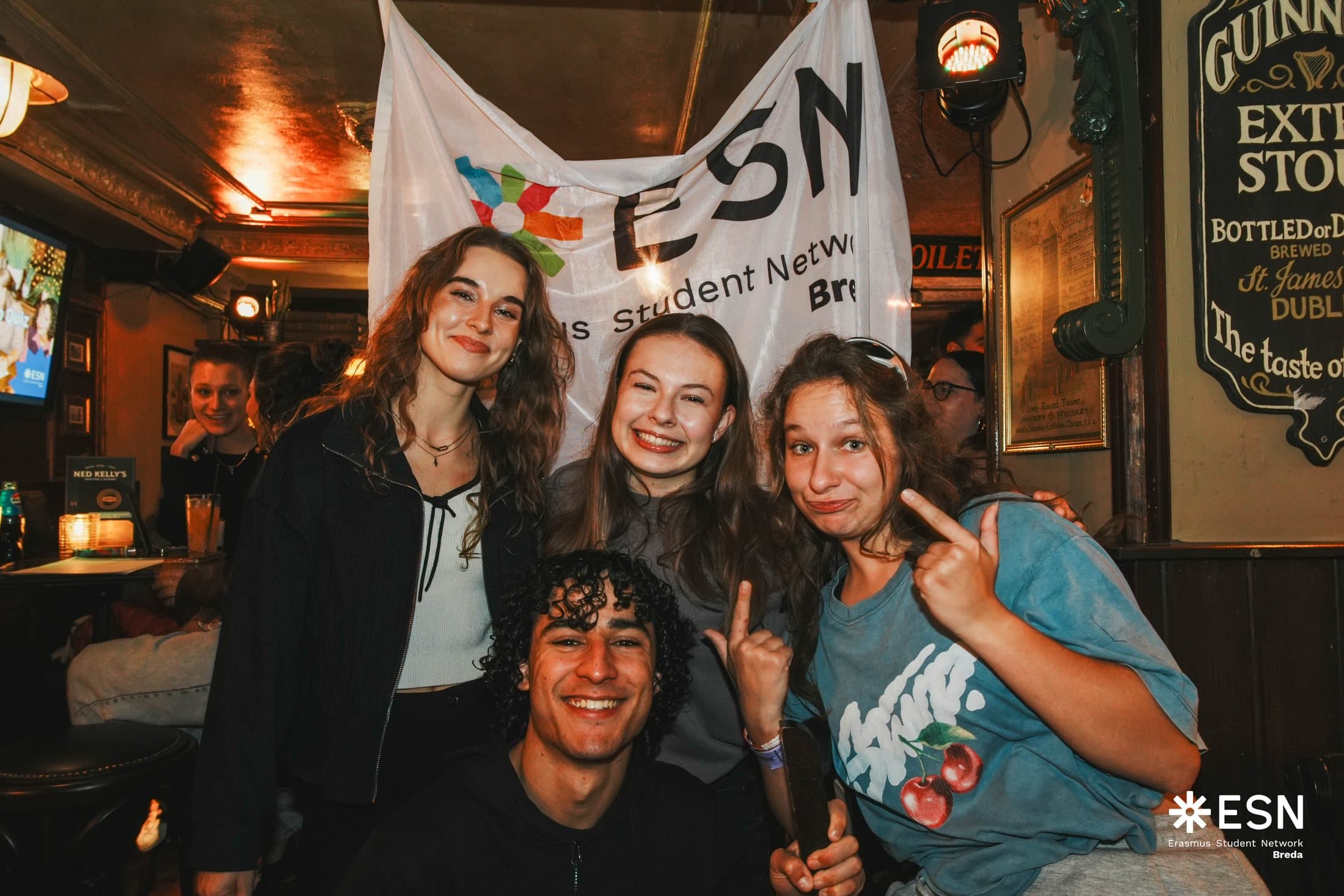 Friends posing together at the ESN Breda pub quiz