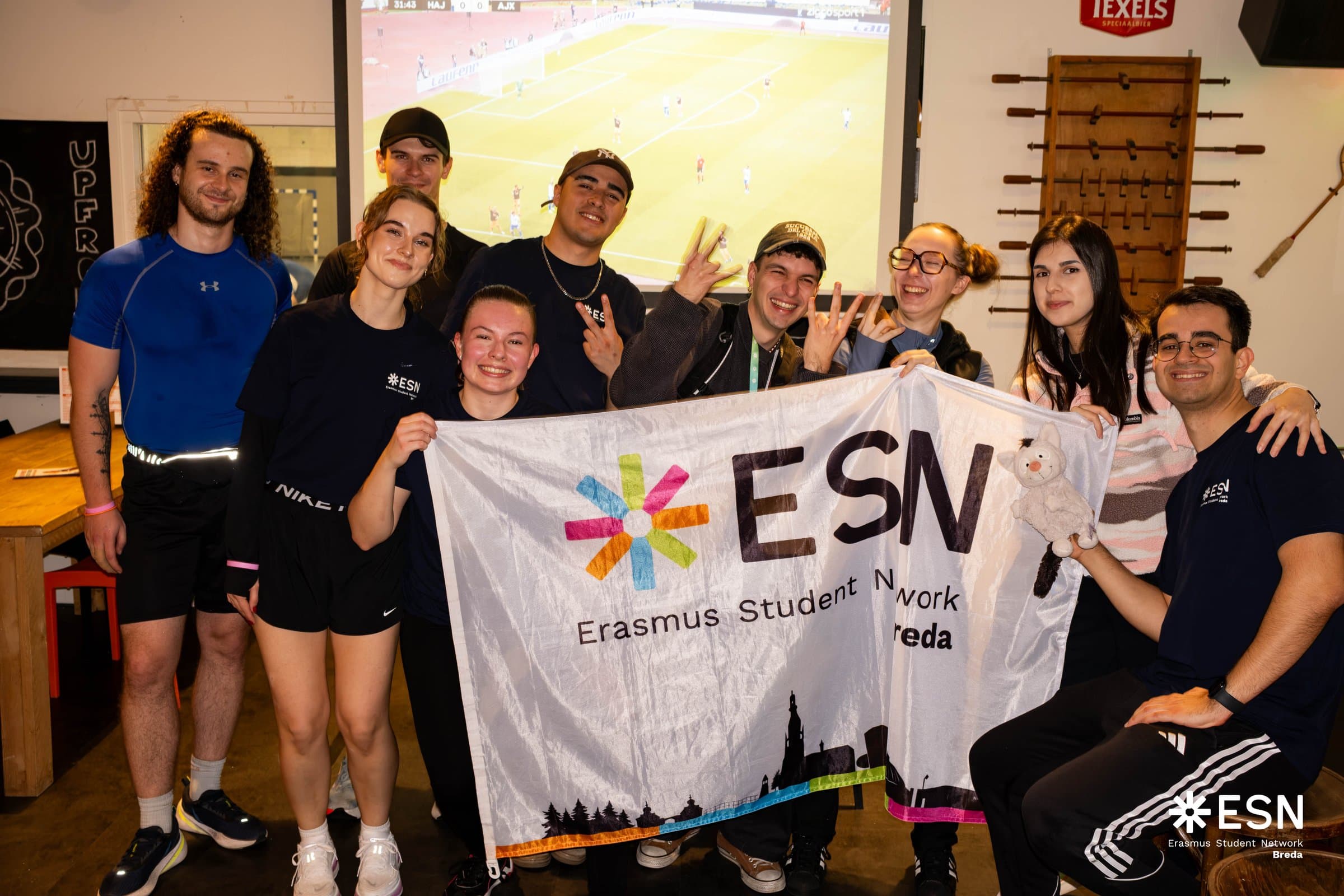 ESN Breda volunteers celebrating together with their team flag